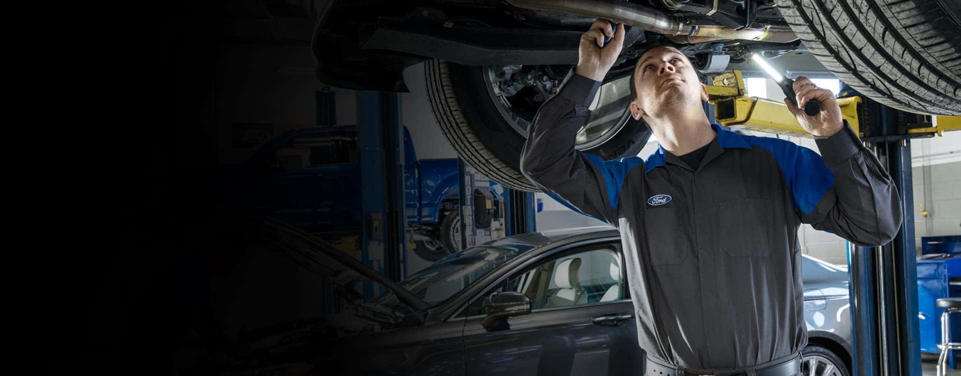 Ford service worker conducting maintenance on vehicle