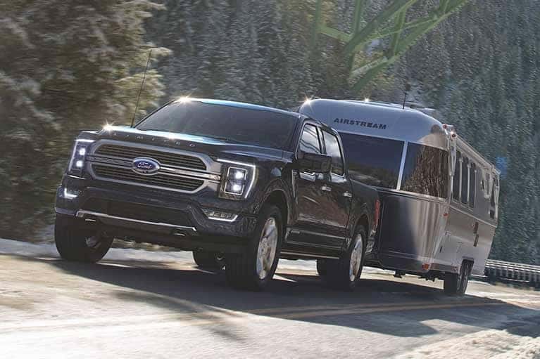 2023 Ford F-150 towing a camper down road
