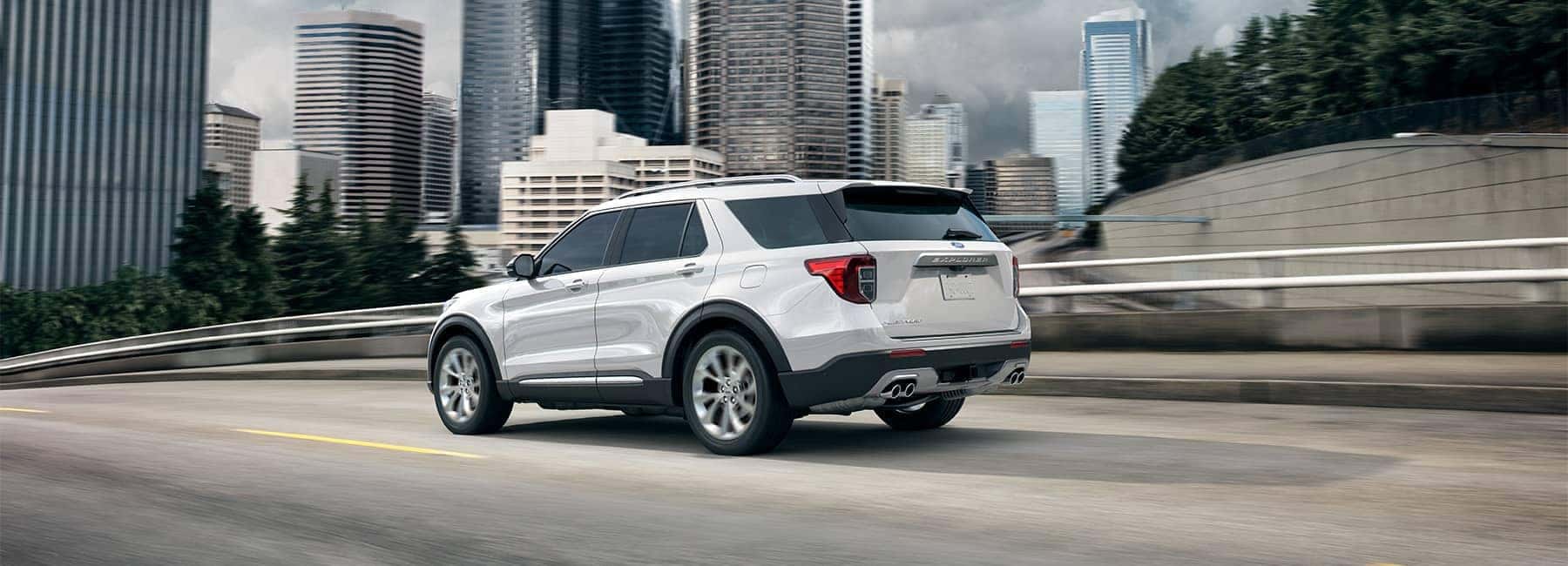 Star White 2022 Ford Explorer on a city highway