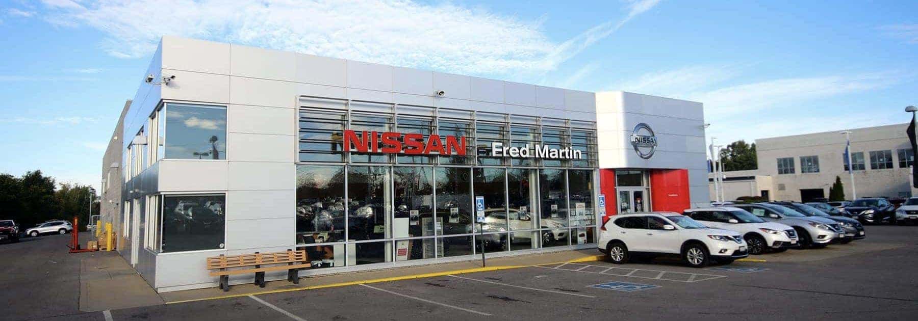 An exterior shot of a Nissan dealership