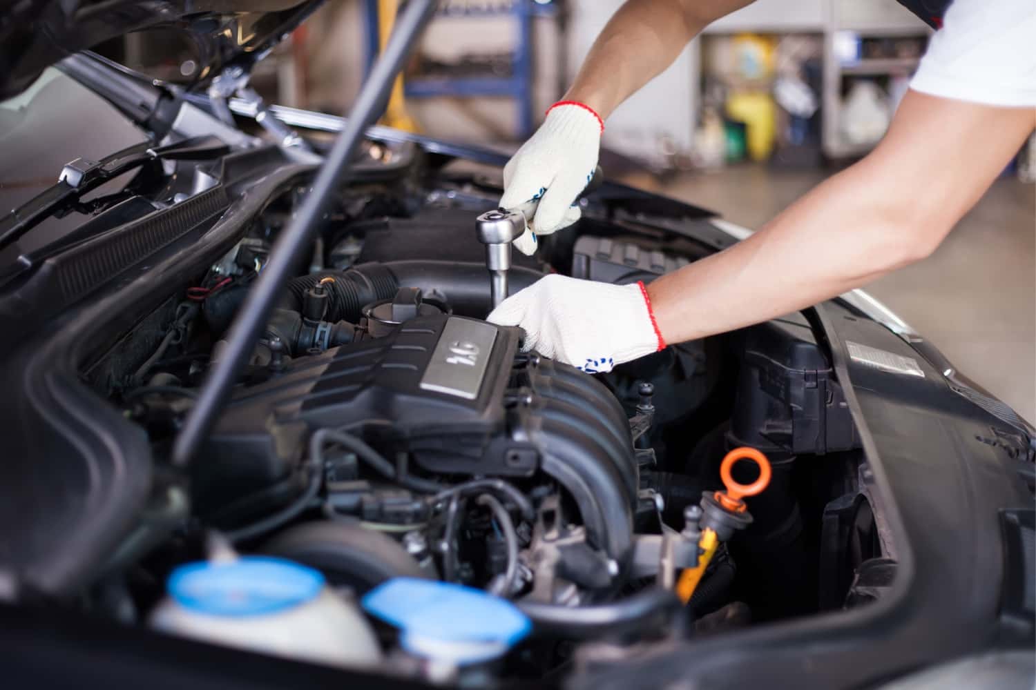 technician-works-on-car-engine