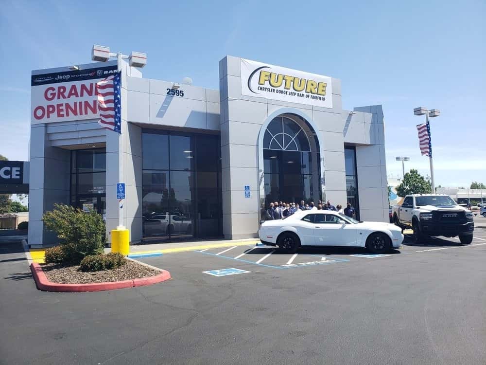 Dealeship-employees-standing-in-front-of-the-dealership-front-doors-angled-view