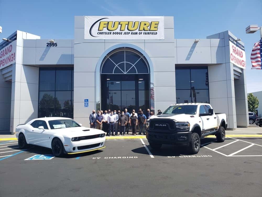 Dealeship-employees-standing-in-front-of-the-dealership-front-doors