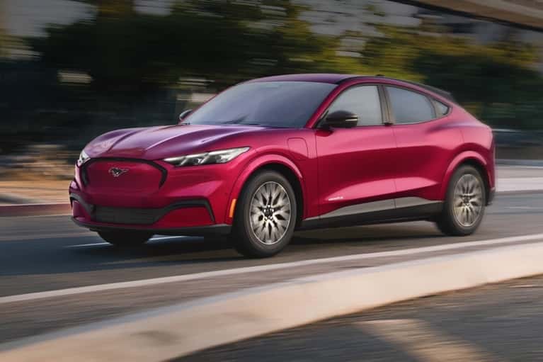 2025-Mustang-Mach-E-speeding-down-a-city-street---mobile