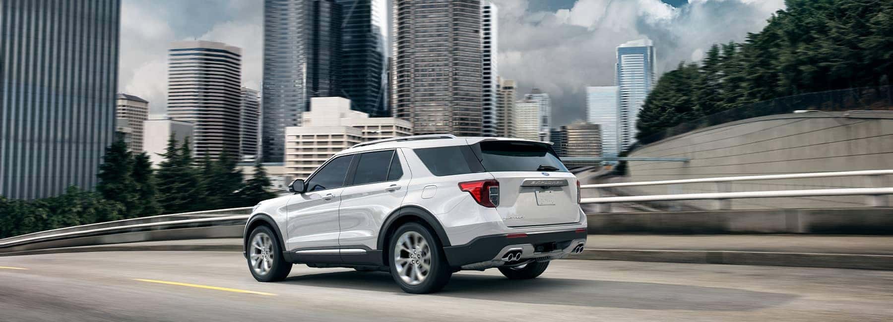 White 2021 Ford Explorer driving through a metropolis