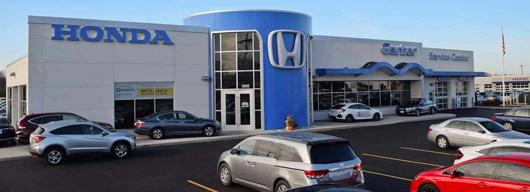 An exterior shot of a Garber Honda dealership in the morning sun.