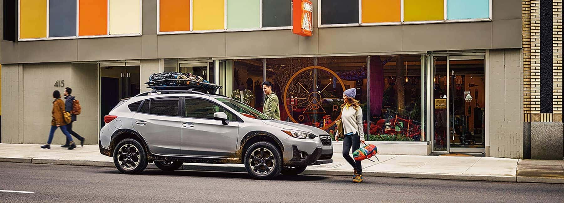 2022 Subaru Crosstrek parked on a city street by a modern downtown building