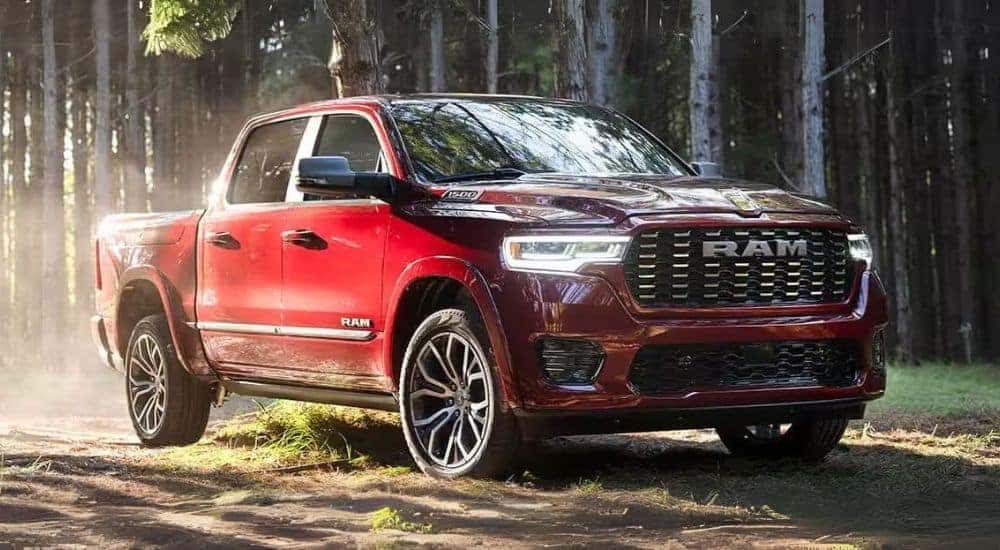 A red 2025 Ram 1500 is shown off-road after leaving a Ram dealer.