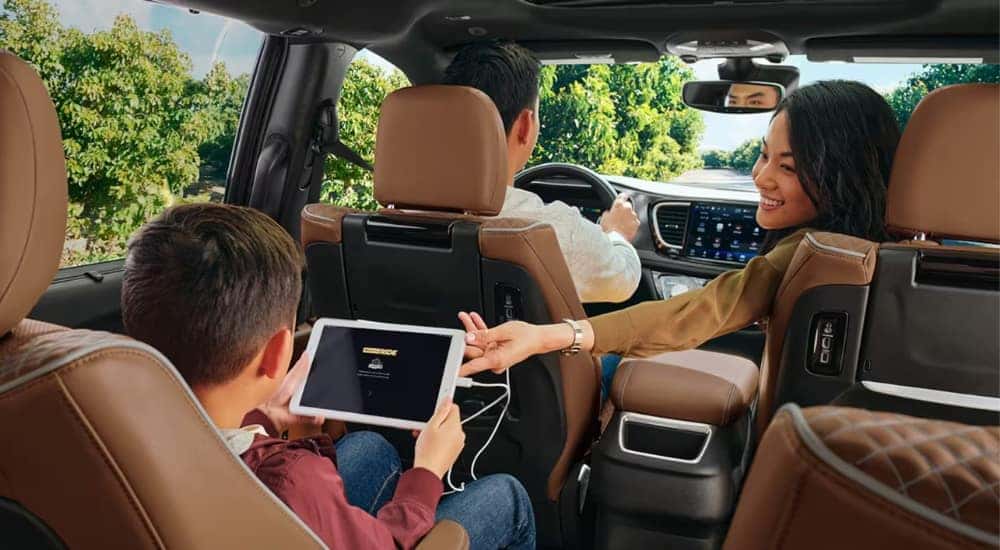A family is shown in a 2023 Chrysler Pacifica.