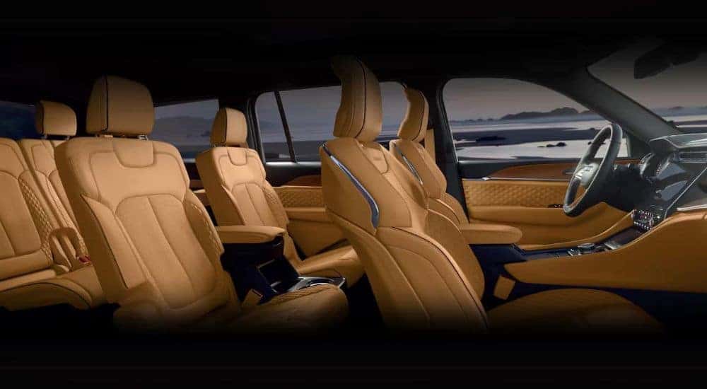 The tan leather seats are shown in a 2024 Jeep Grand Cherokee L.