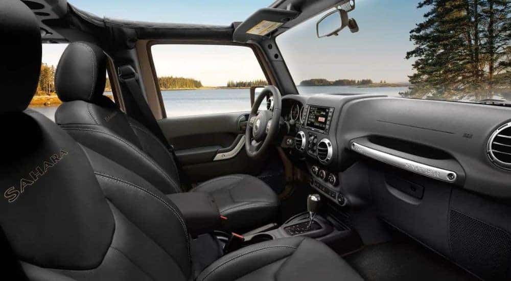 The black interior is shown in a 2017 Jeep Wrangler Sahara Unlimited.