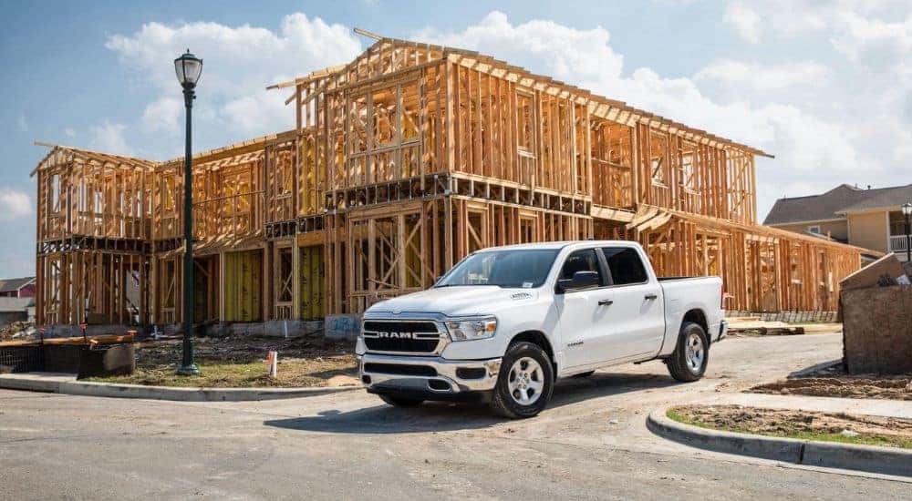 A white 2022 Ram 1500 Classic is shown near a building being constructed.