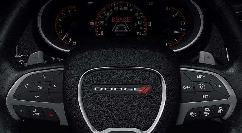 A close-up shows the steering wheel in a 2016 Dodge Durango.