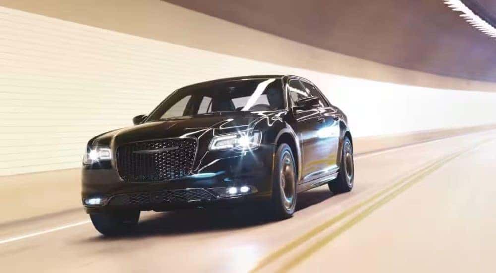 A black 2024 Chrysler 300 driving down a tunnel from a Chrysler dealer near Charlotte.