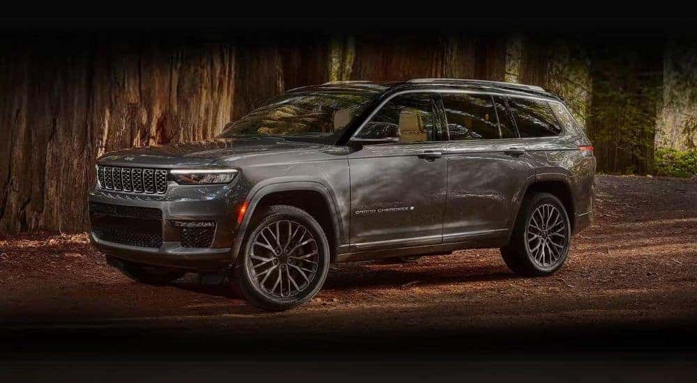 A grey 2024 Jeep Grand Cherokee L is shown parked off-road.