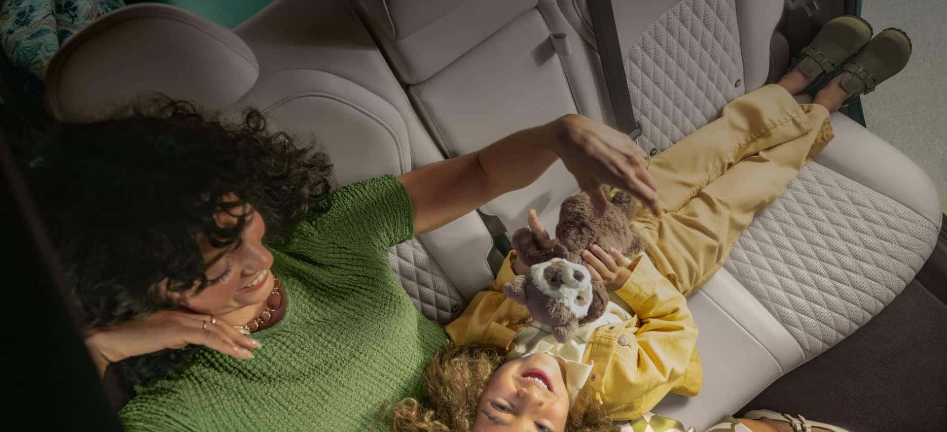 Mother and child resting in the backseat of a vehicle