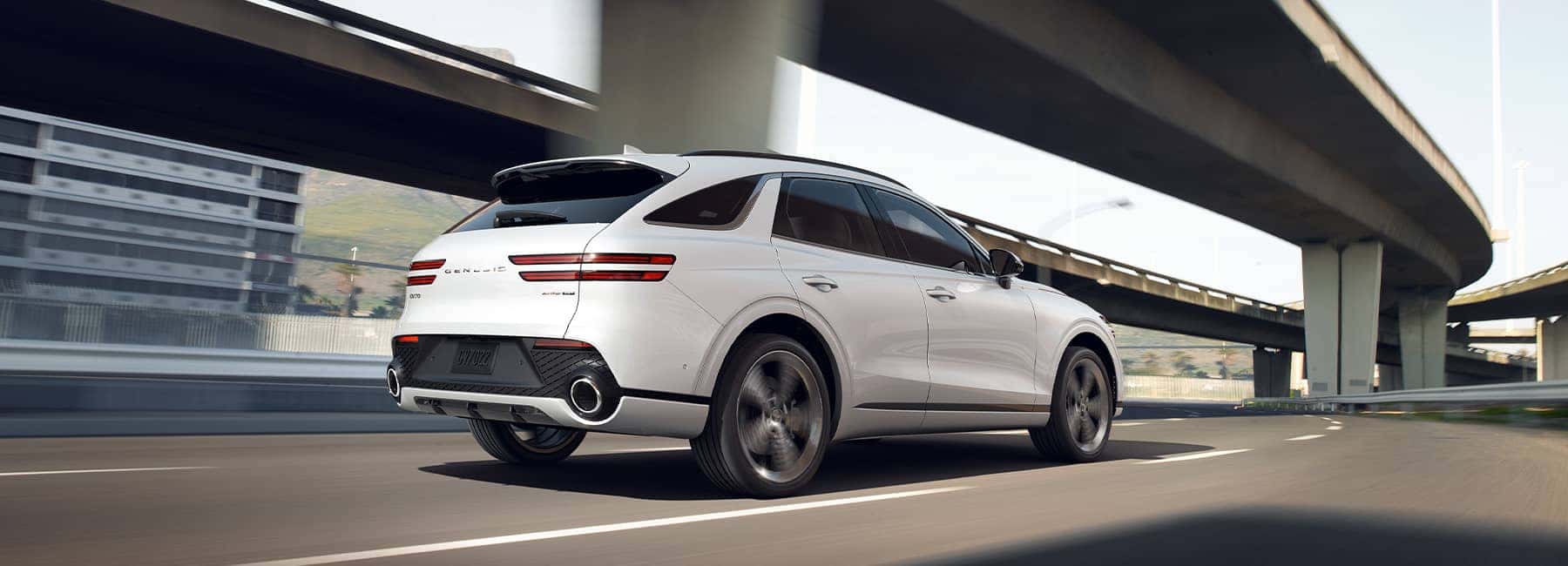White 2022 Genesis GV70 driving away
