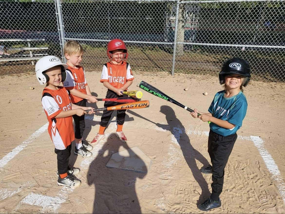 Four kids playing baseball
