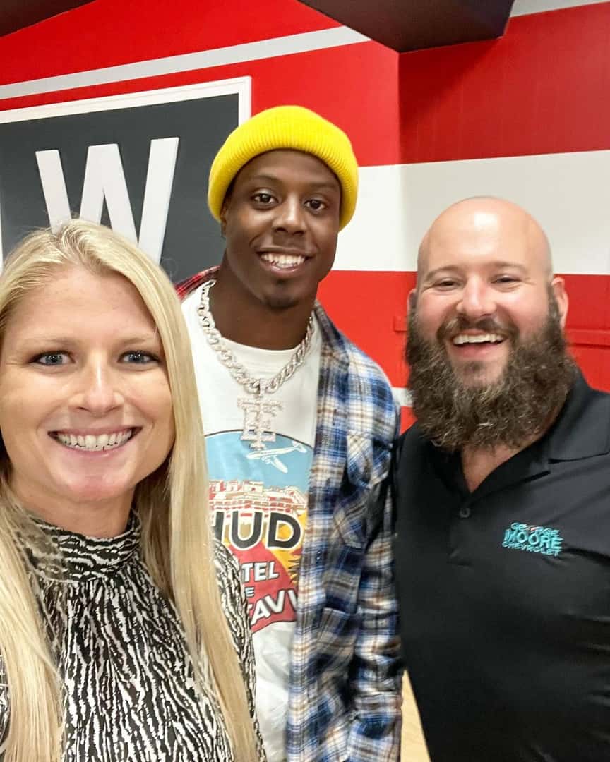 Three people smiling