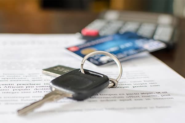 Vehicle keys on top of documents
