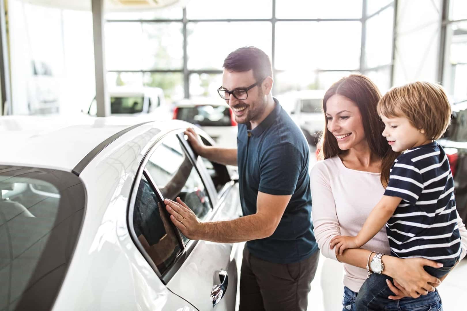 Family viewing car in dealership
