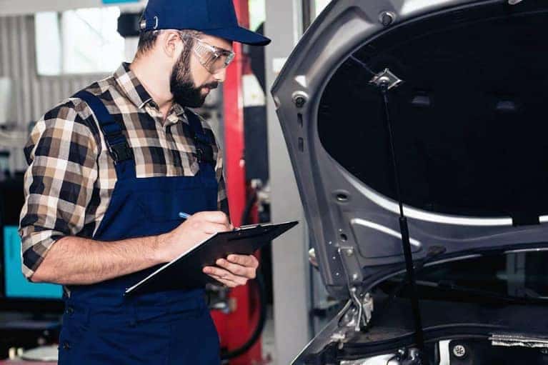 Mechanic Writing Report on Clipboard
