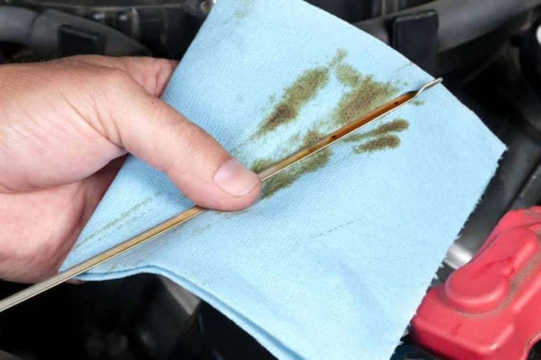 Mechanic checking oil levels