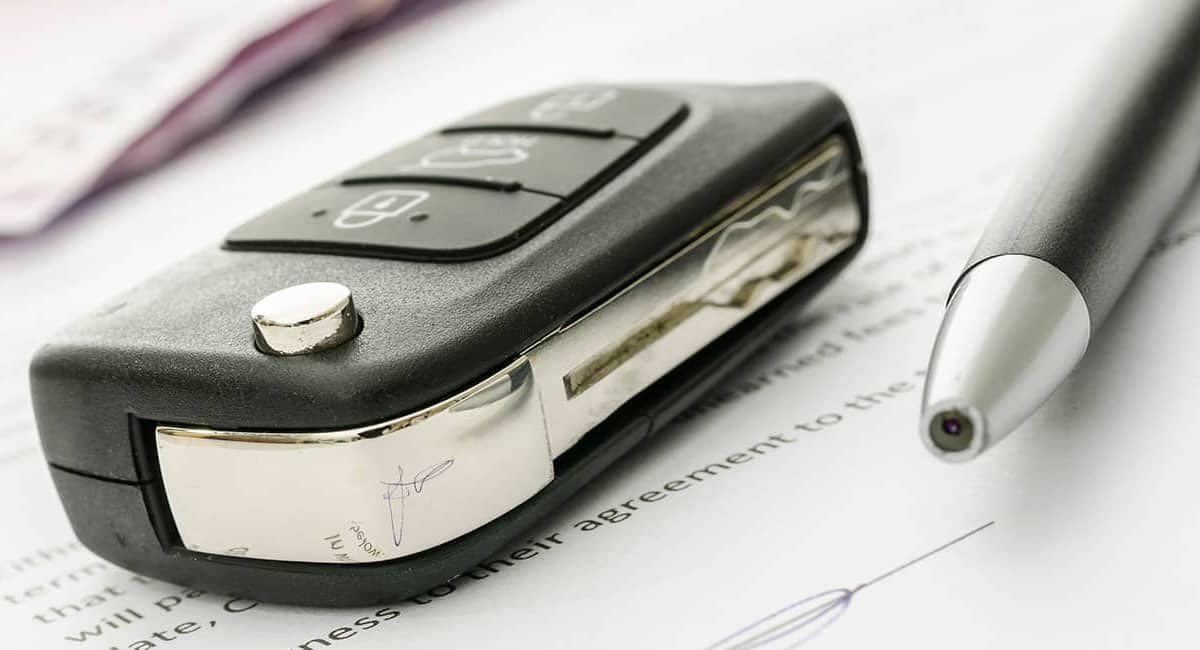 Car Key and Pen on Documents
