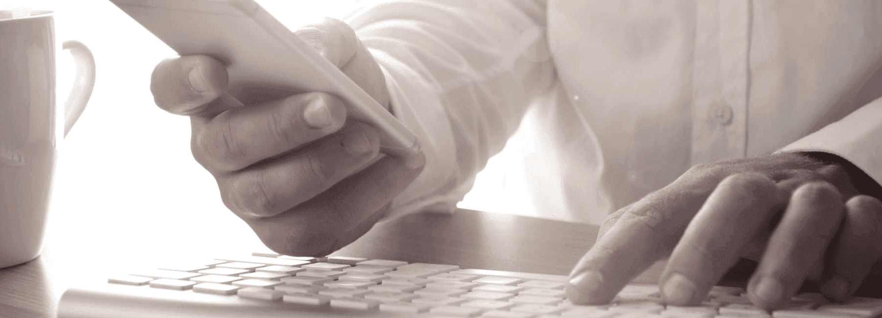 man-using-smartphone and keyboard