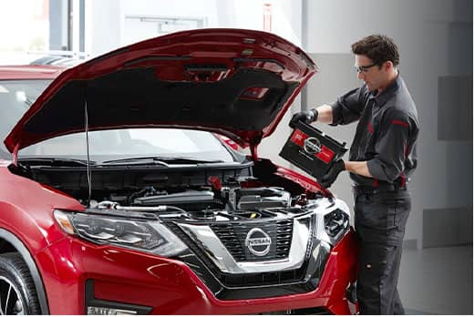 Nissan technician adding a car battery