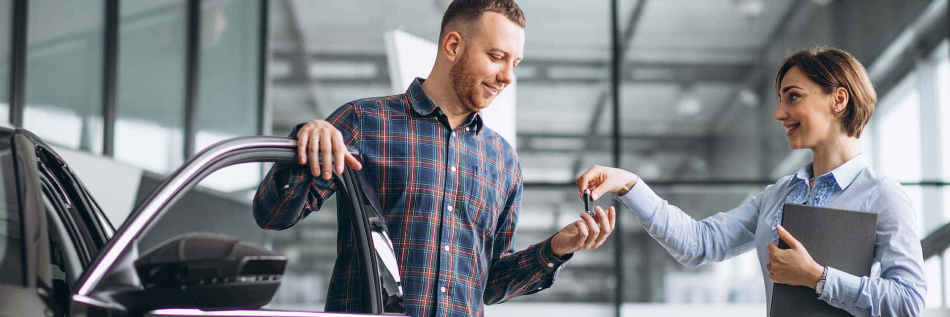 woman handing man key to car