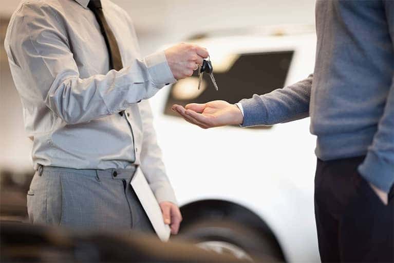 Salesman Handing Car Keys to Man