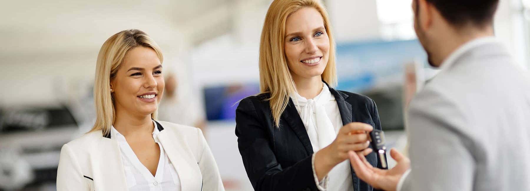Woman Handing Car Key to a Man