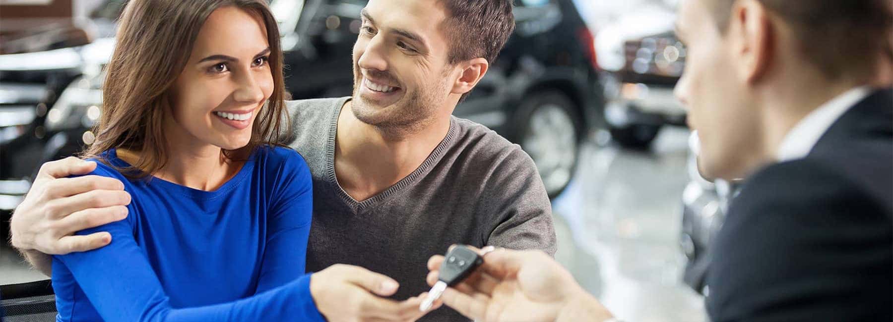 Salesman Handing Couple Keys