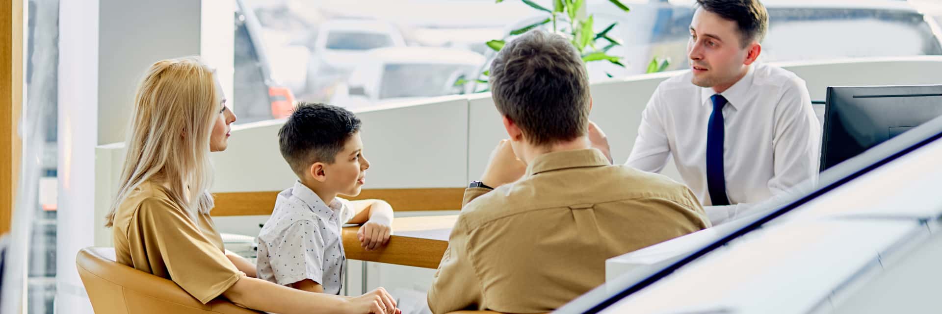 Family looking at finance documents with a sales person