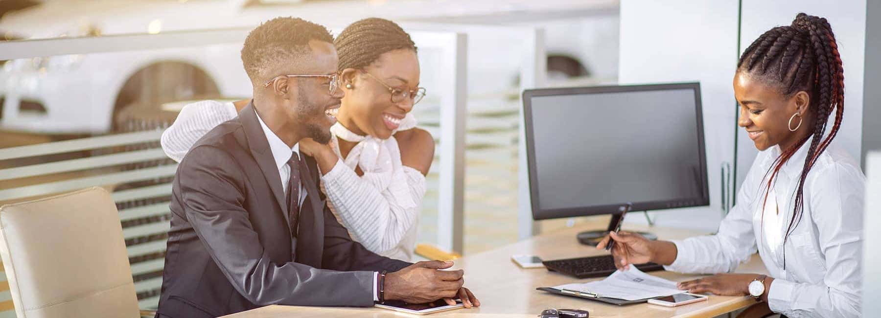 Couple Buying a New Car in Finance Office