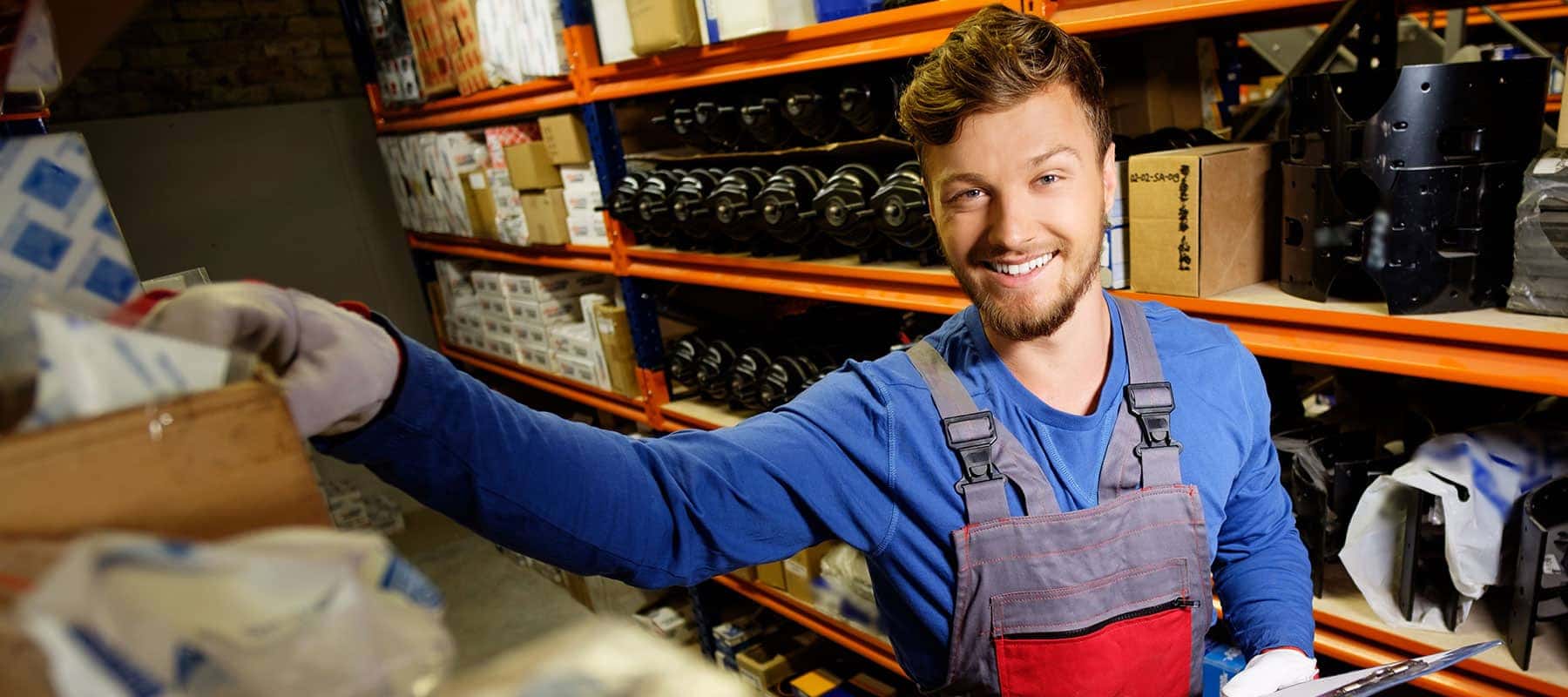 Parts attendant reaching for shelf