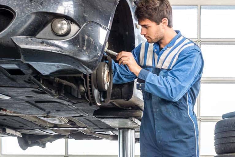 mechanic works on brakes
