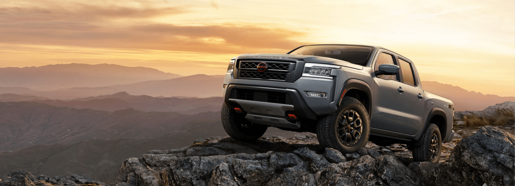 2023 gray-nissan-frontier-side-view-on-mountain