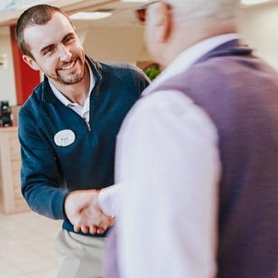 Product specialist shaking a guests hand