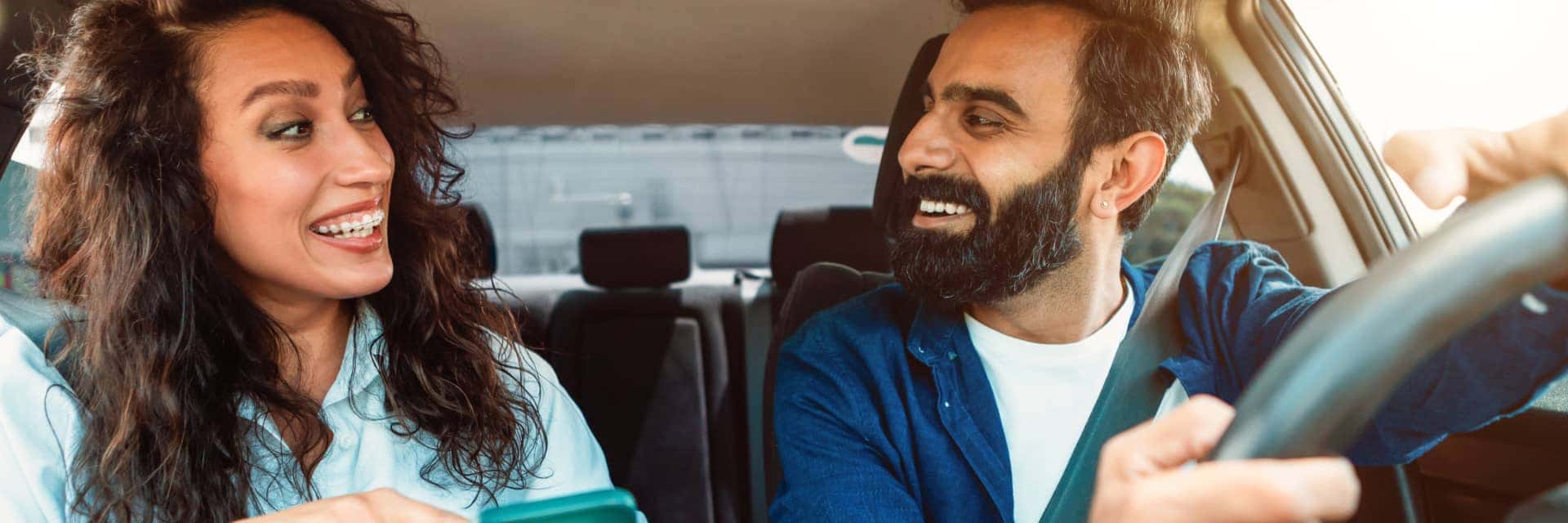 man and woman looking at each other in vehicle