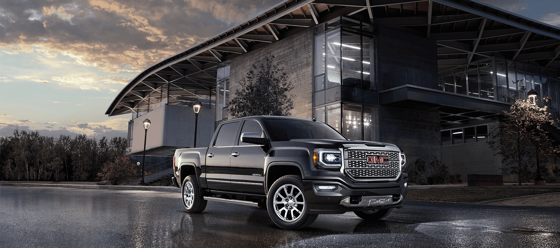 A black GMC truck outside of a dealership