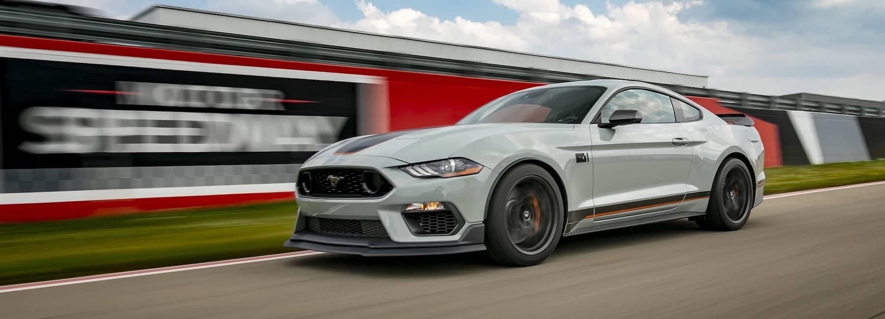 2023 Grey Mustang racing on the track.