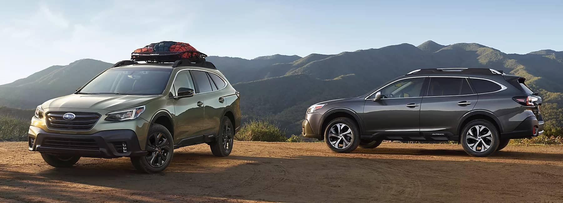 2022-Subaru-Outback-hero-2-parked-cars-in-mountain-range-background