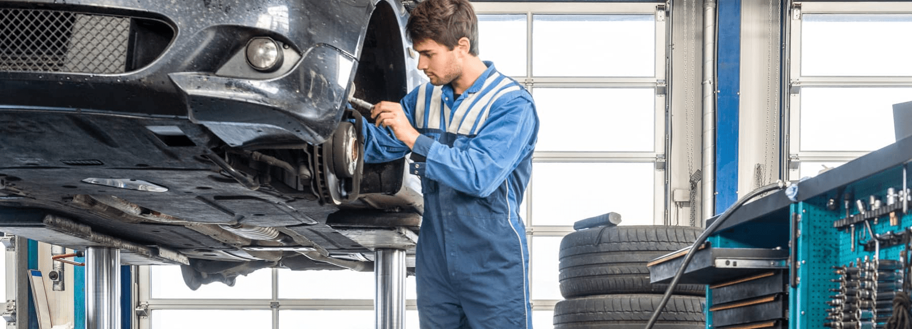 mechanic-repairs-car-brakes-in-service-bay