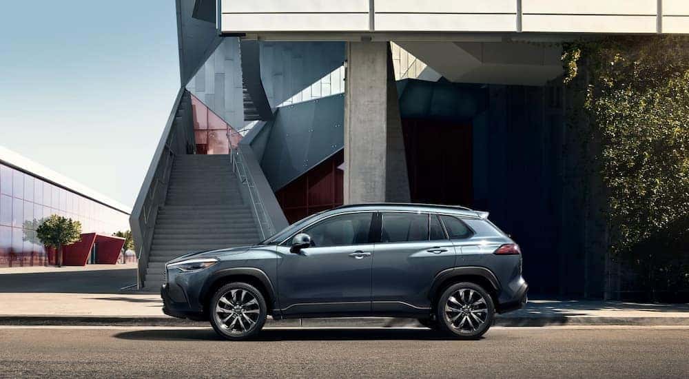 A grey 2022 Toyota Cross is shown from the side leaving a Toyota dealer near you.