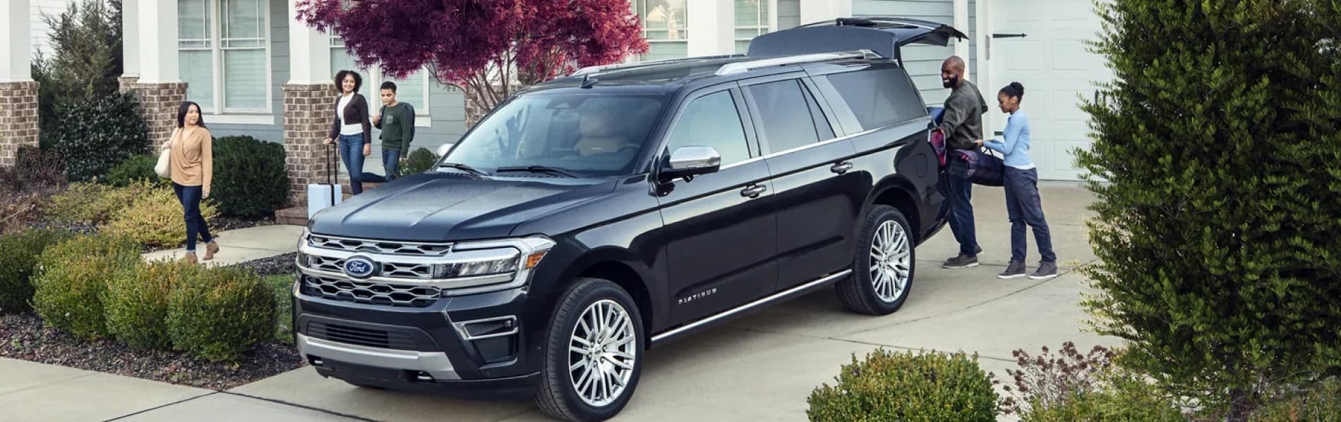 Black Ford SUV with family