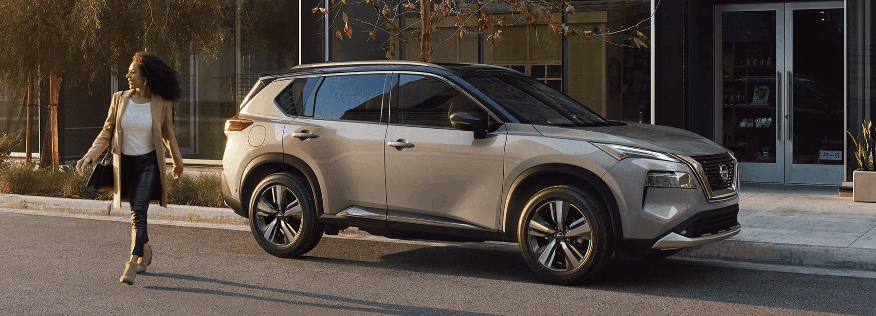 2023-nissan-rogue-sideview-woman-walks-from
