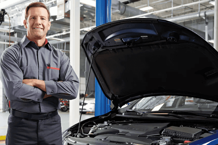 smiling-Nissan-technician-arms-crossed