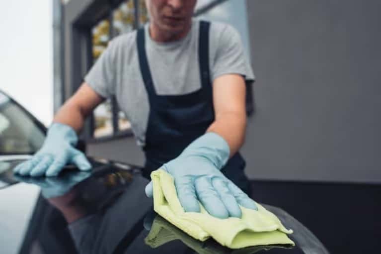 A cleaning cloth on a hood of a car
